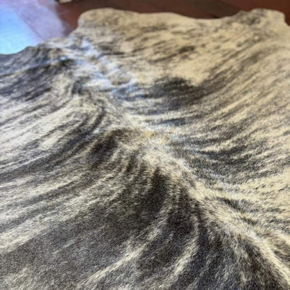 Detalhe das bordas do tapete de couro de boi Brazino Claro peça única e artesanal