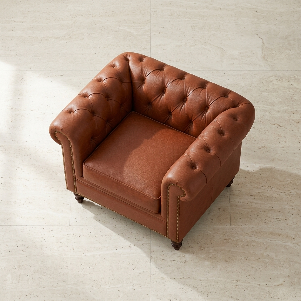 Poltrona Chesterfield Terracota em vista superior diagonal sobre piso claro, mostrando o assento solto
